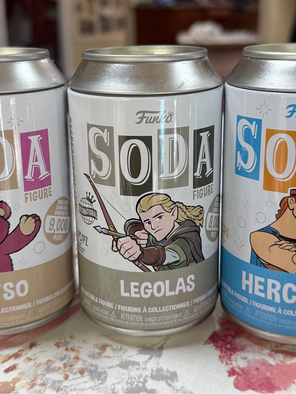 3 Funko Soda Figure Cans - Legolas, Hercules and Lotso from Toy Story.
